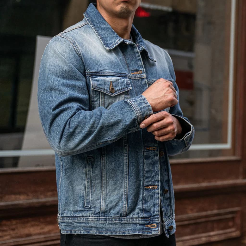 Man wearing a blue denim jacket.