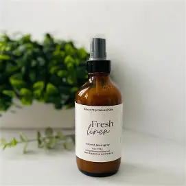 A bottle of fresh linen room spray.